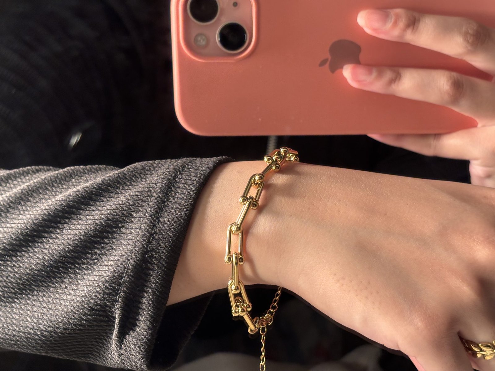 Chunky gold bracelet worn on the wrist