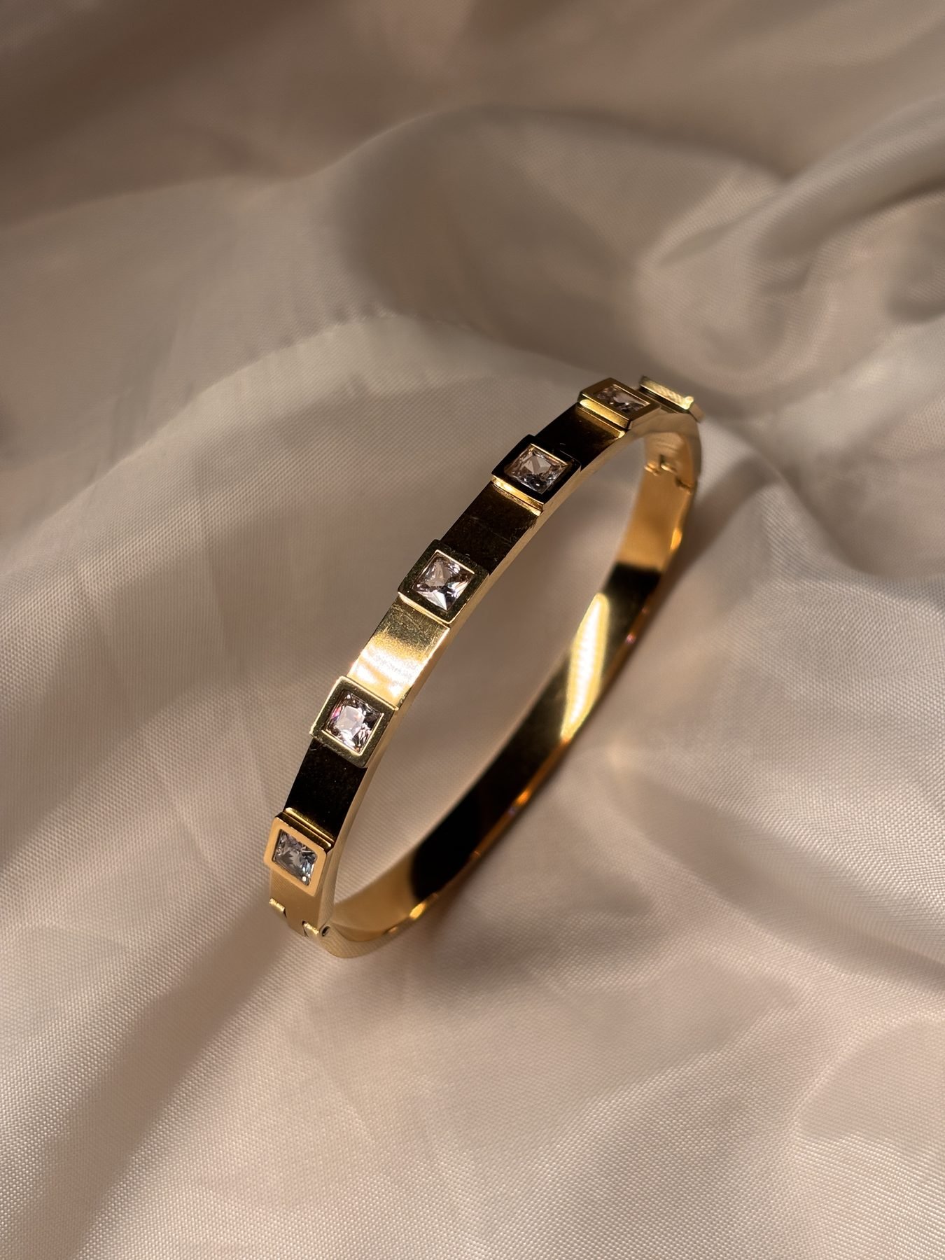 Gold bangle set with princess-cut stones