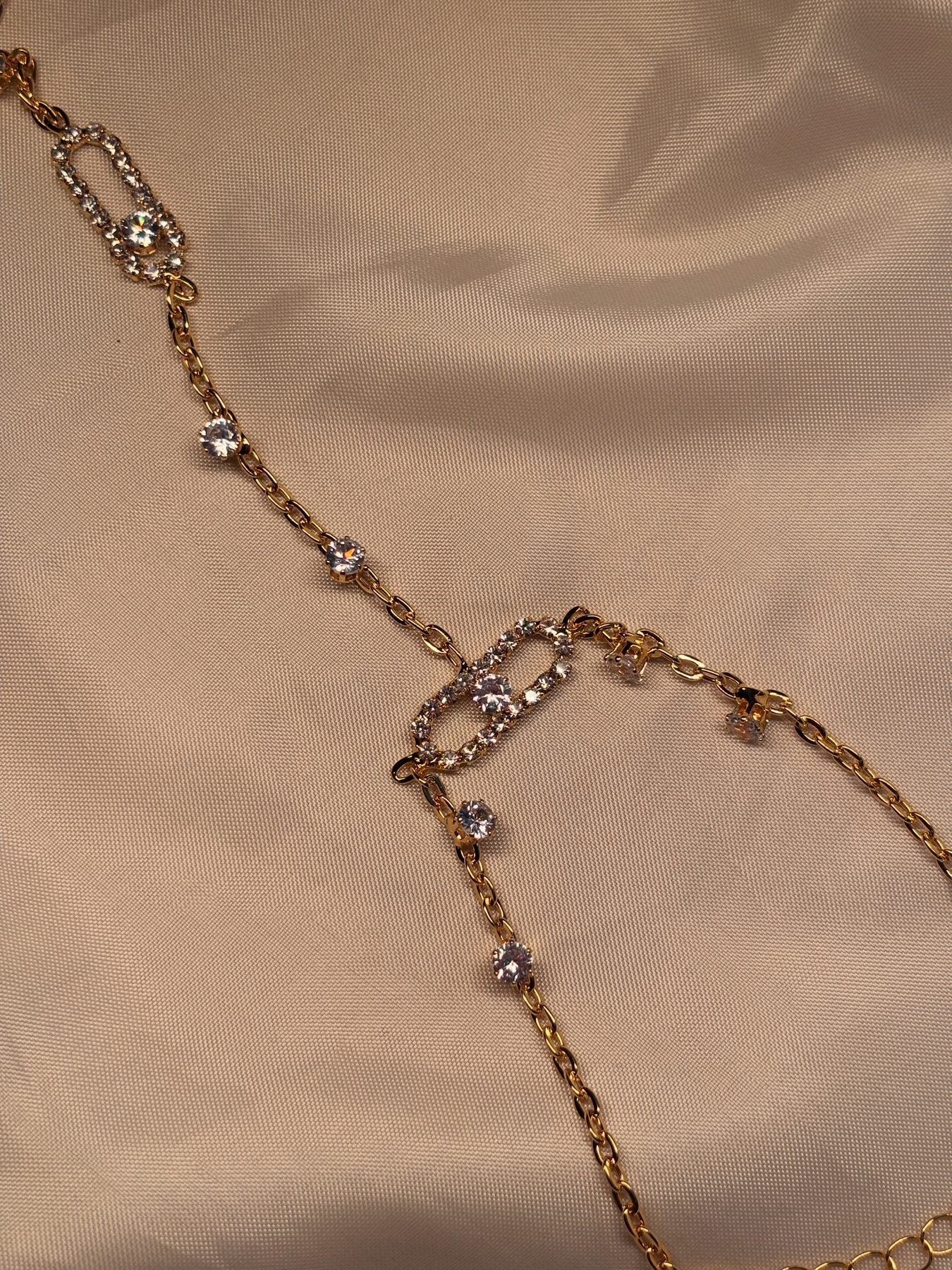 The Statement Hand Chain on cream silk with oval stone-set links